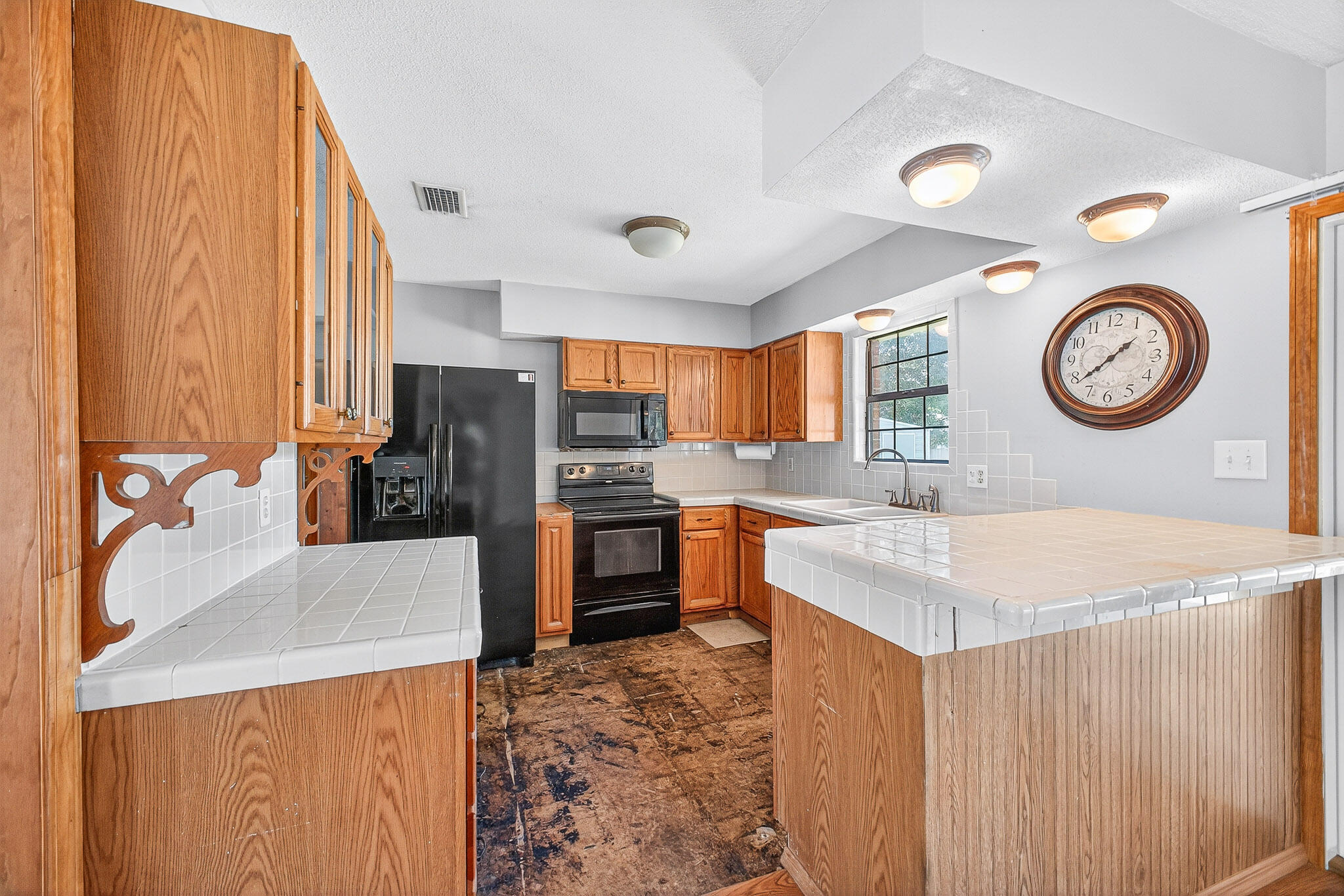 121 Boyce Road Shalimar, FL 32579 - Photo 10 of 34 a kitchen with a refrigerator and a stove top oven