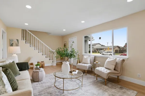 a living room with furniture and wooden floor