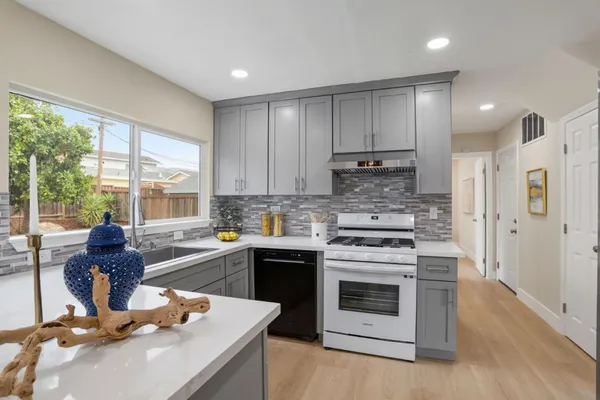 a kitchen with a stove a sink and a refrigerator
