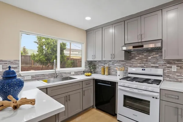 a kitchen with a sink stove and cabinets