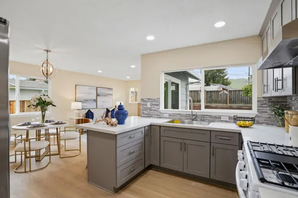 a kitchen with a sink stove and cabinets