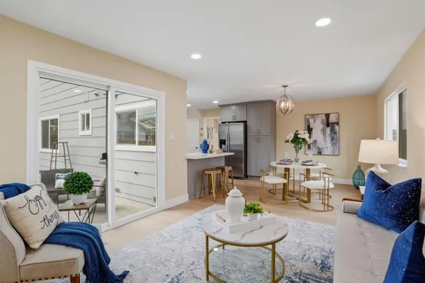 a living room with furniture kitchen and a table