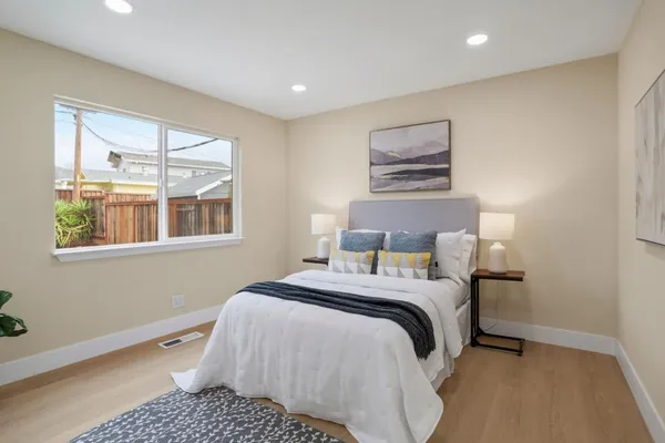 a bedroom with a bed and a window
