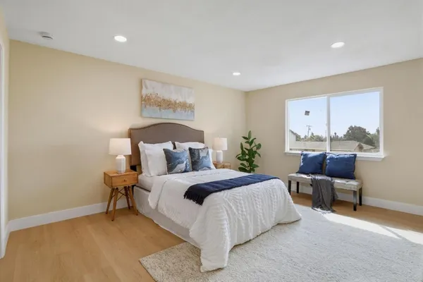 a bedroom with a bed and a chair