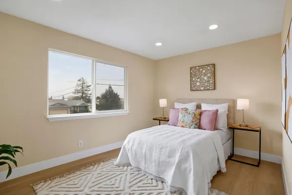a bedroom with a bed and a painting on the wall