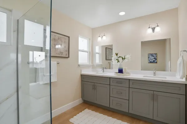 a bathroom with a double vanity sink and mirror