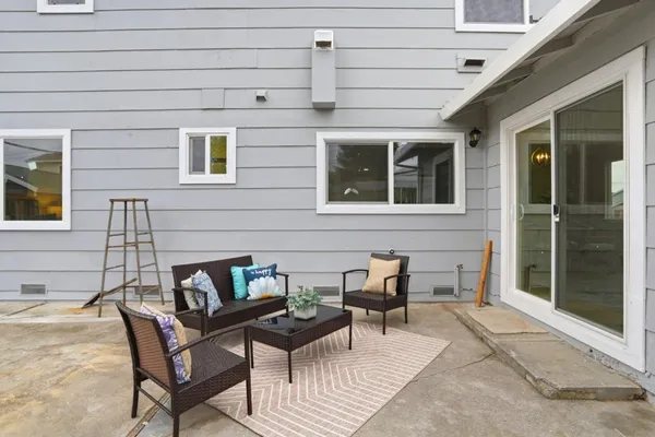 a view of a patio with couple of chairs