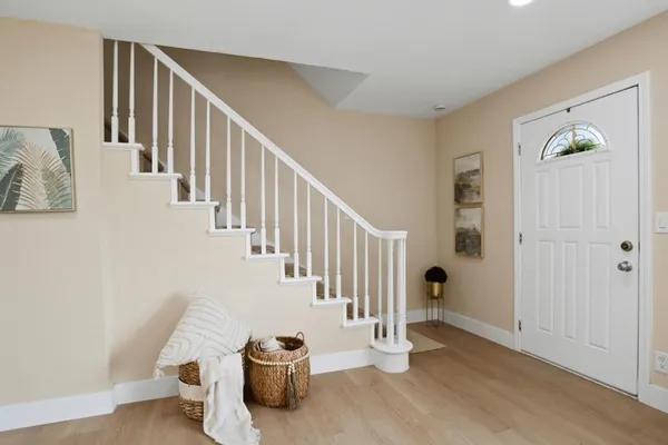 a view of a hallway with staircase and white walls