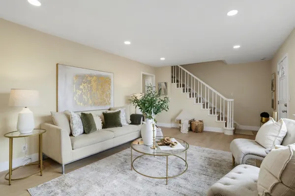a living room with furniture and wooden floor
