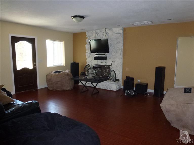 4591 Apricot Road Simi Valley, CA 93063 - Photo 12 of 15 a living room with furniture and a flat screen tv