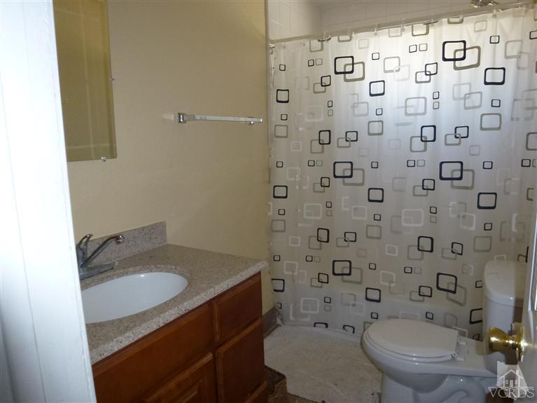4591 Apricot Road Simi Valley, CA 93063 - Photo 14 of 15 a bathroom with a granite countertop toilet and a sink