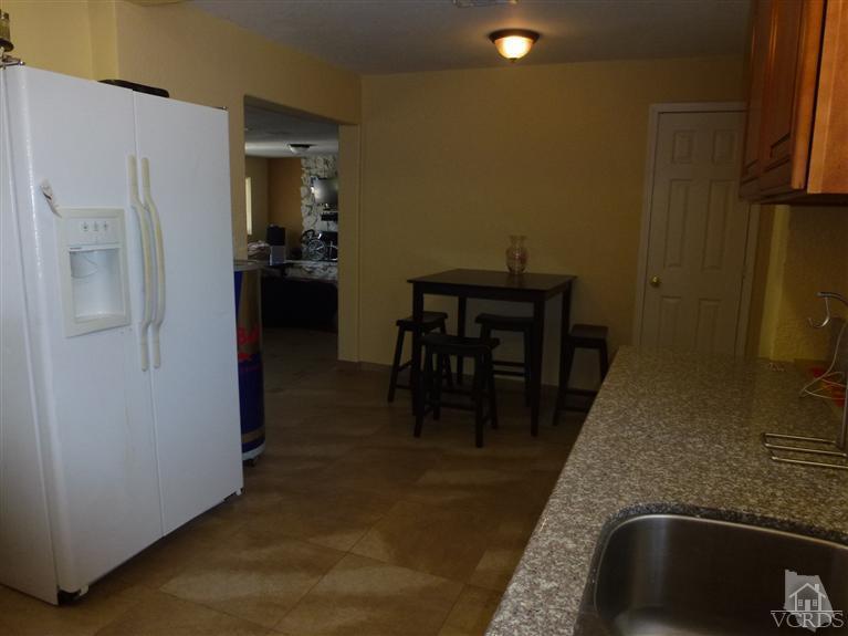 4591 Apricot Road Simi Valley, CA 93063 - Photo 8 of 15 a room with stainless steel appliances kitchen island granite countertop furniture and a refrigerator