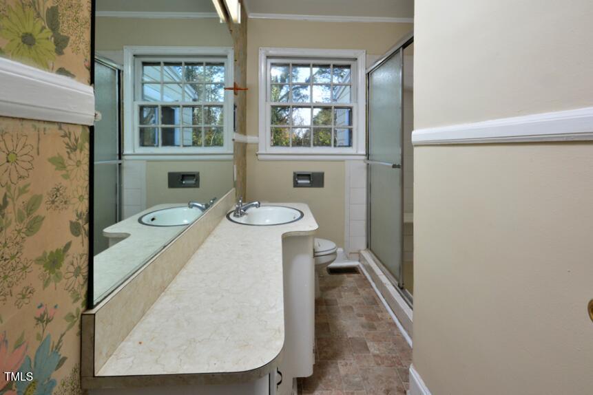 1817 Hillcrest Drive Durham, NC 27705 - Photo 11 of 29 a view of a bathroom with a sink and a window