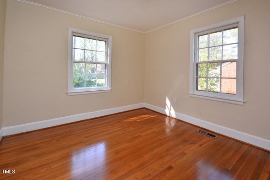 1817 Hillcrest Drive Durham, NC 27705 - Photo 13 of 29 an empty room with wooden floor and windows