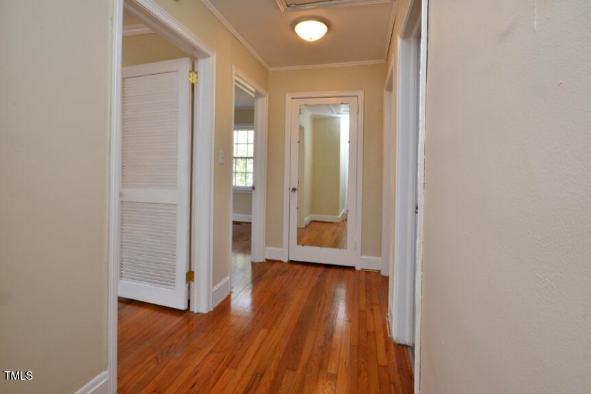 1817 Hillcrest Drive Durham, NC 27705 - Photo 15 of 29 an empty room with wooden floor and door