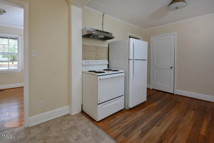 1817 Hillcrest Drive Durham, NC 27705 - Photo 17 of 29 a kitchen with a refrigerator and a stove top oven