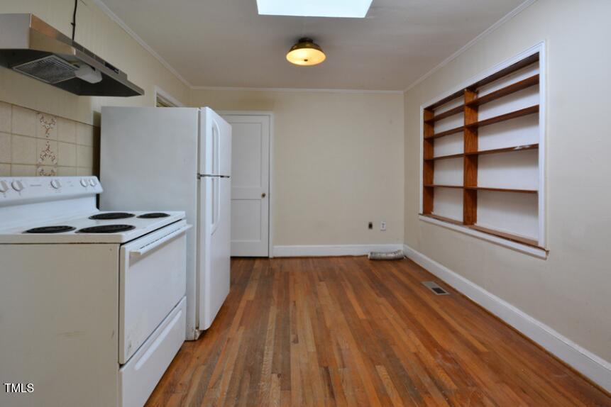 1817 Hillcrest Drive Durham, NC 27705 - Photo 18 of 29 a kitchen with a wooden floor and white appliances