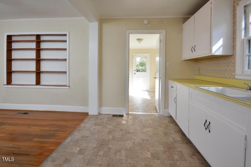 1817 Hillcrest Drive Durham, NC 27705 - Photo 19 of 29 a view of a kitchen with wooden floor and a window