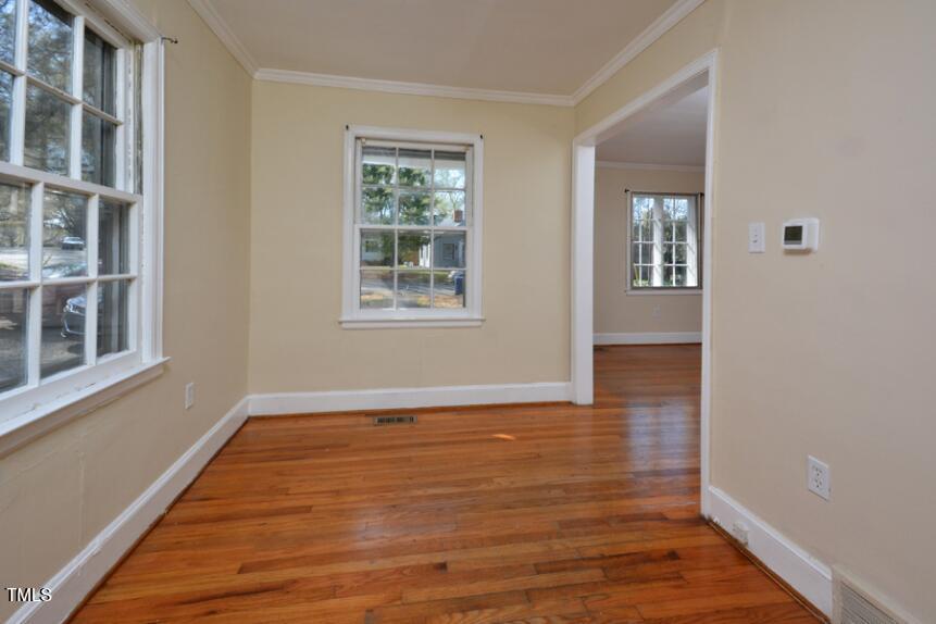 1817 Hillcrest Drive Durham, NC 27705 - Photo 25 of 29 a view of an empty room with wooden floor and a window