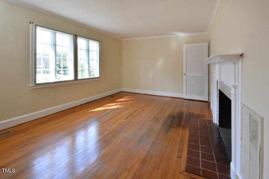 1817 Hillcrest Drive Durham, NC 27705 - Photo 28 of 29 an empty room with wooden floor and a window
