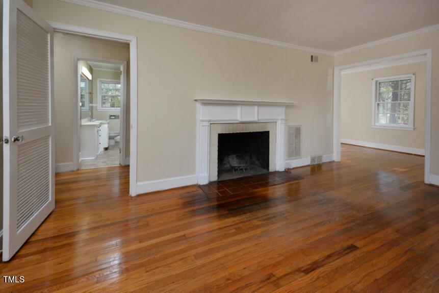 1817 Hillcrest Drive Durham, NC 27705 - Photo 10 of 29 wooden floor fireplace and natural light in room