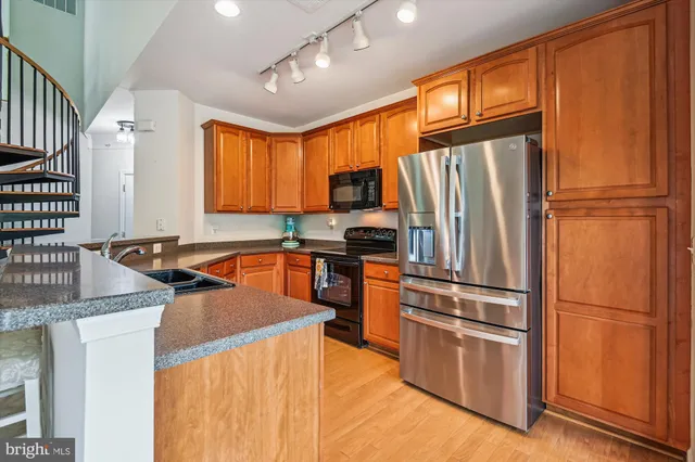 a kitchen with stainless steel appliances granite countertop a sink and a stove