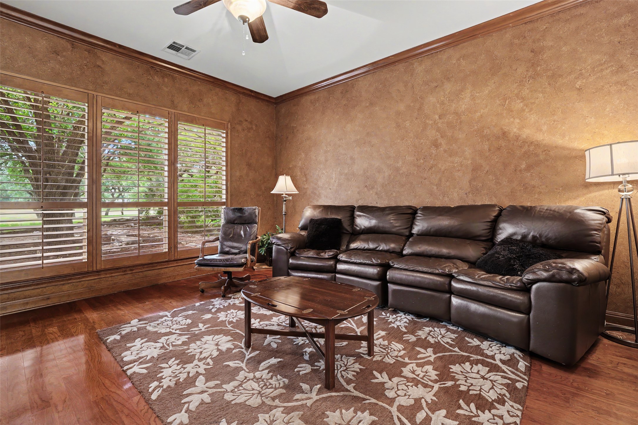 33 Meadows End Georgetown, TX 78628 - Photo 31 of 40 Rich hardwood floors complement custom window shutters in this inviting living space.