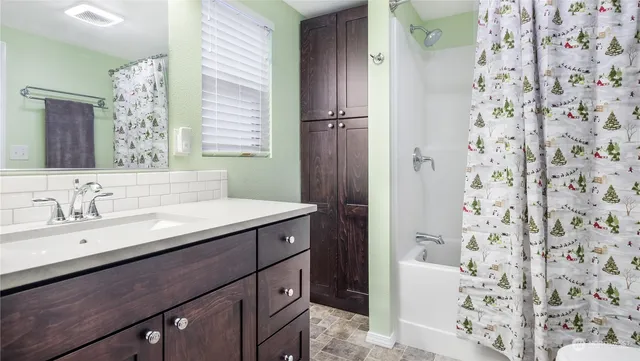 an aerial view of a house with a yard and lake view