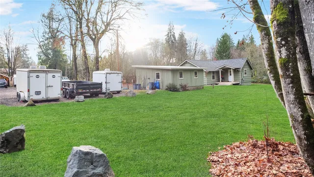 a view of yard with swimming pool and green space