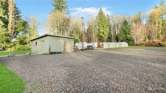 a view of a house with backyard and sitting area