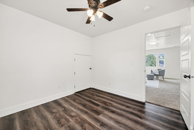 1552 Sumac Drive Logan, UT 84321 - Photo 37 of 72 Room featuring wood-finish flooring, white baseboards, a ceiling fan with integrated lighting, and a white door with black hardware