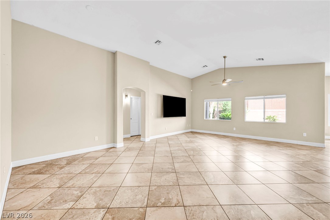 6405 North Raptor Court North Las Vegas, NV 89084 - Photo 11 of 66 A spacious common area with vaulted ceilings and ceramic tile flooring offers a welcoming atmosphere.