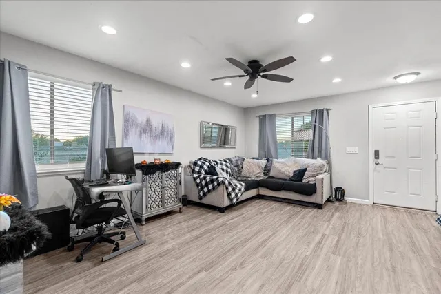a living room with furniture and a wooden floor