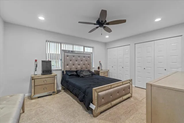 a bedroom with a bed and a ceiling fan