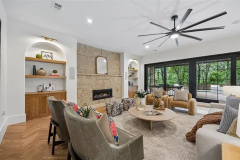 a living room with furniture fireplace and a large window