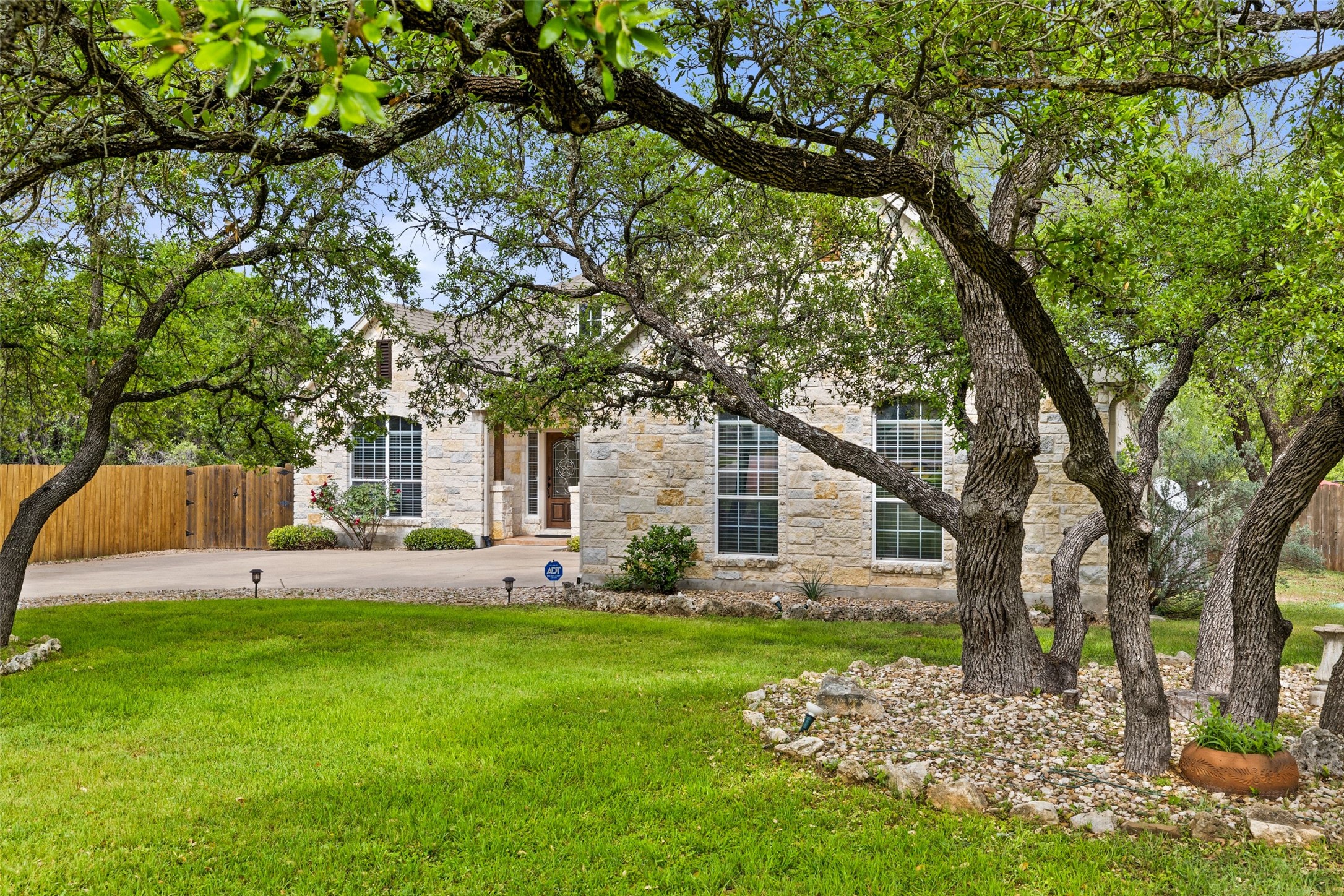 15208 Nightingale Lane Austin, TX 78734 - Photo 7 of 40 Obstructed view of property featuring stone siding