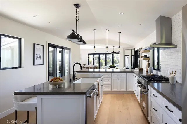 a kitchen with counter top space a sink stainless steel appliances and cabinets