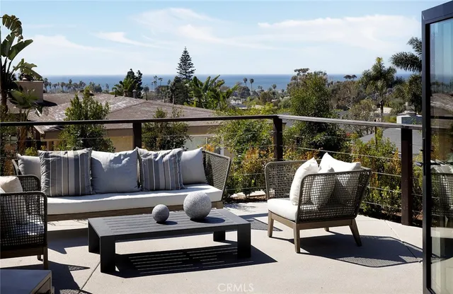 a roof deck with couches and wooden floor