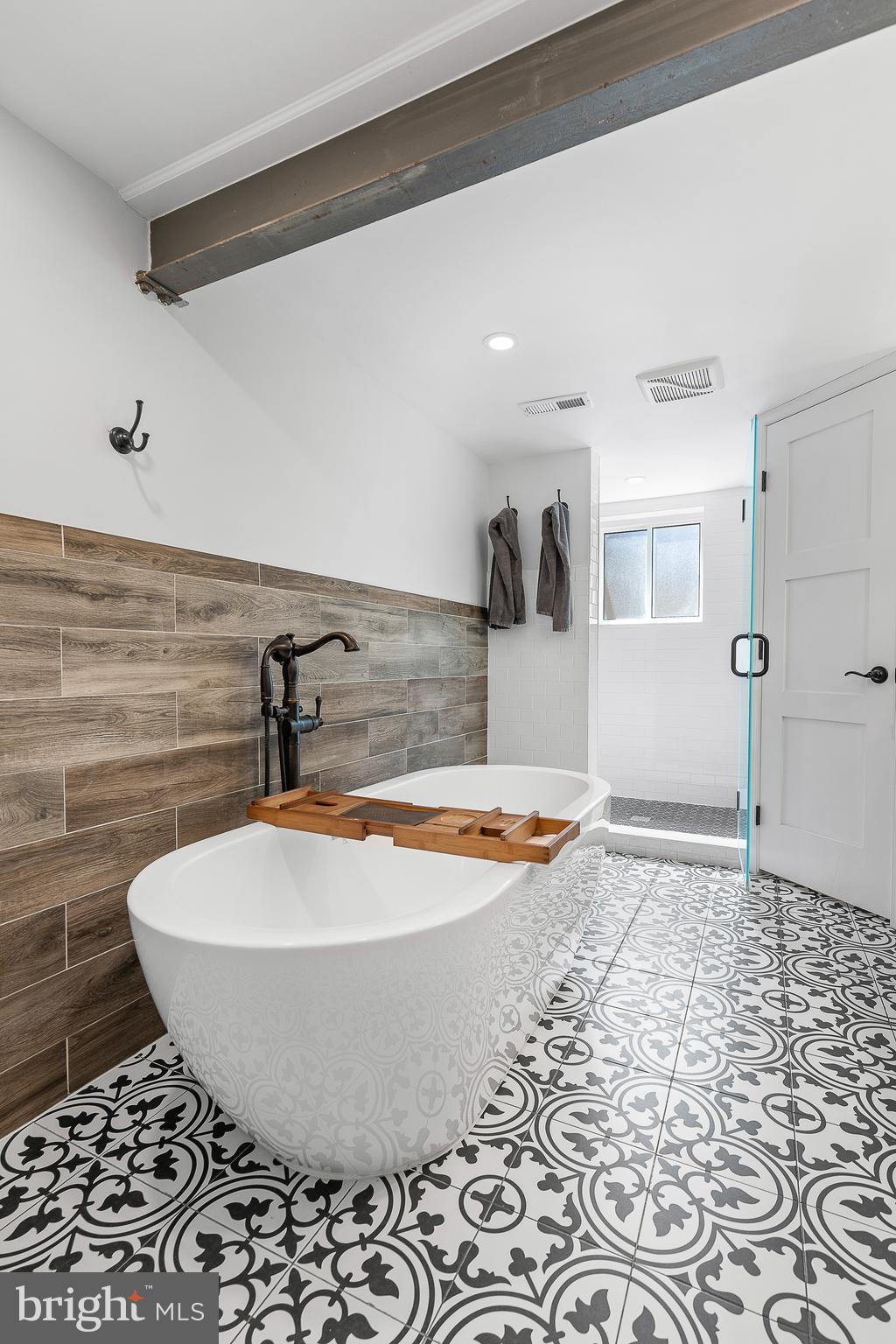 6492 Little Falls Road Arlington, VA 22213 - Photo 26 of 45 Soaking tub with exposed beam and wood wall