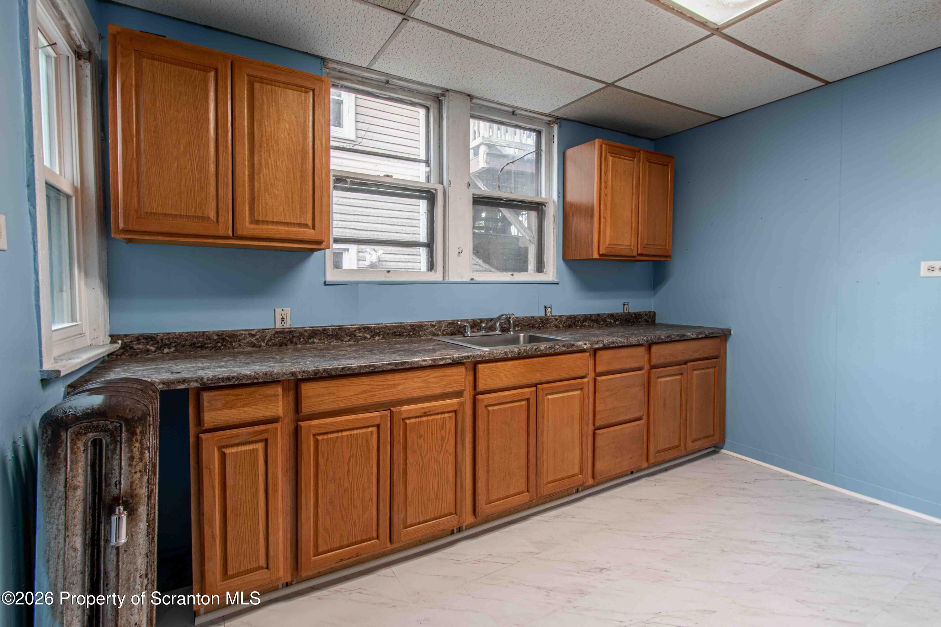844 Monroe Avenue, Unit 844 Scranton, PA 18510 - Photo 9 of 15 a kitchen with stainless steel appliances granite countertop cabinets and window