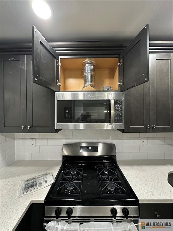 3303 Hana Road Edison, NJ 08817 - Photo 17 of 47 a stove top oven sitting inside of a kitchen