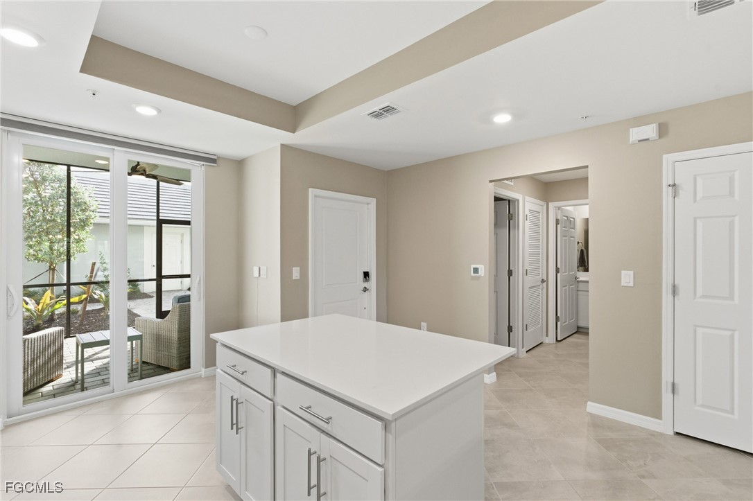 44000 Boardwalk Loop, Unit 1312 Punta Gorda, FL 33982 - Photo 21 of 48 a kitchen with a stove a refrigerator a sink and dishwasher with a dining table
