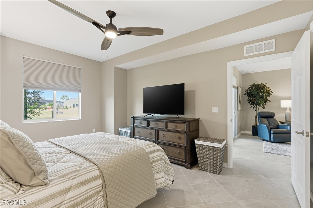 44000 Boardwalk Loop, Unit 1312 Punta Gorda, FL 33982 - Photo 25 of 48 a bedroom with a bed and a flat screen tv