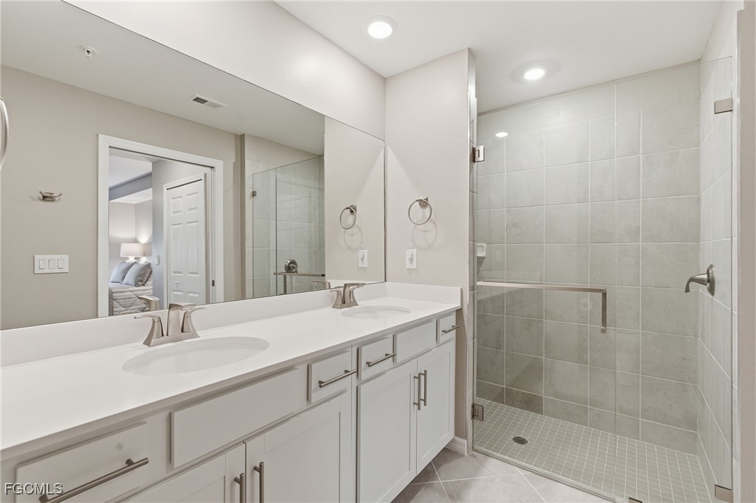 44000 Boardwalk Loop, Unit 1312 Punta Gorda, FL 33982 - Photo 28 of 48 a bathroom with a shower sink and mirror