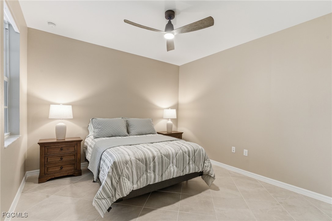 44000 Boardwalk Loop, Unit 1312 Punta Gorda, FL 33982 - Photo 29 of 48 a bedroom with a bed and a ceiling fan