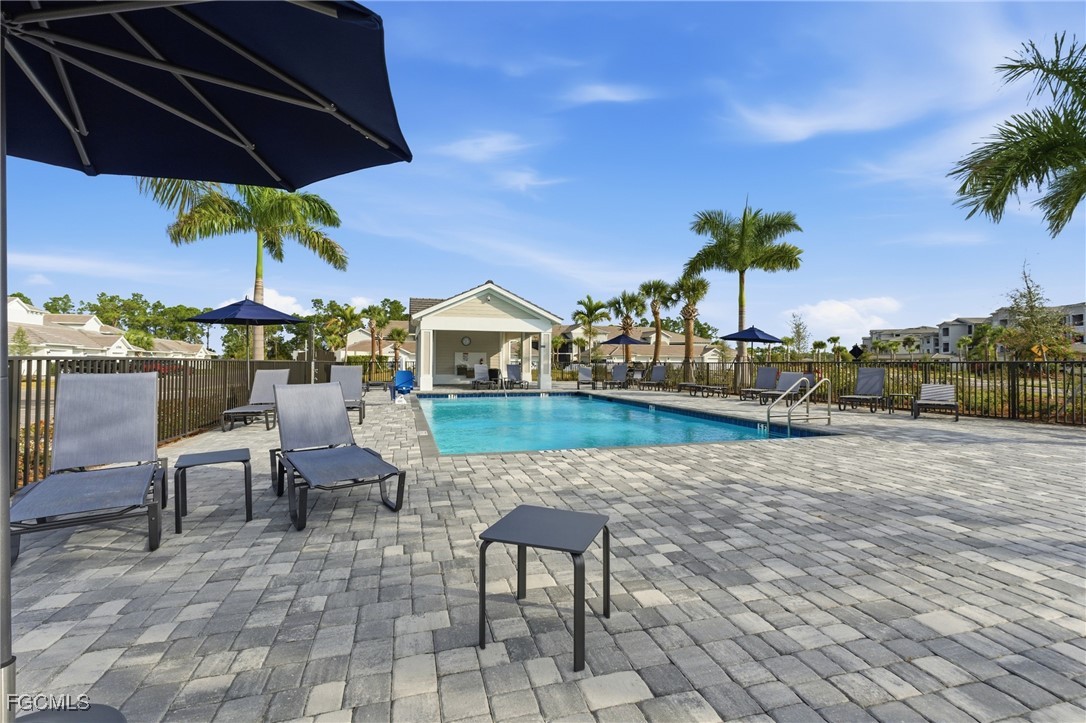 44000 Boardwalk Loop, Unit 1312 Punta Gorda, FL 33982 - Photo 32 of 48 a view of a patio with chairs under an umbrella