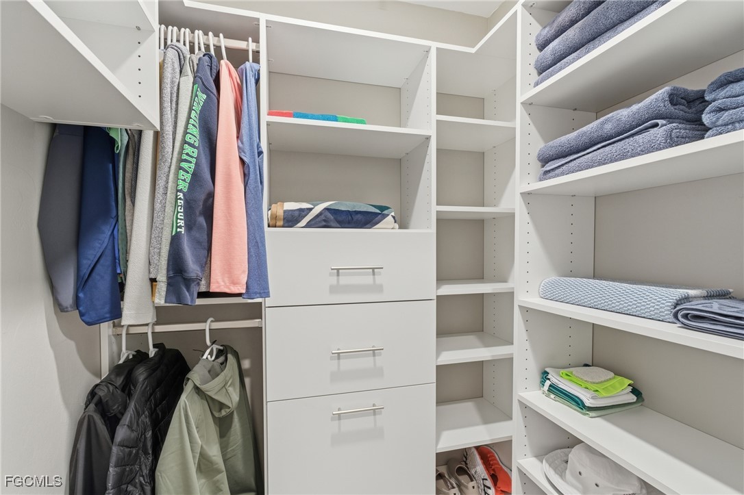 44000 Boardwalk Loop, Unit 1312 Punta Gorda, FL 33982 - Photo 35 of 48 a view of walk in closet with clothes and shoes