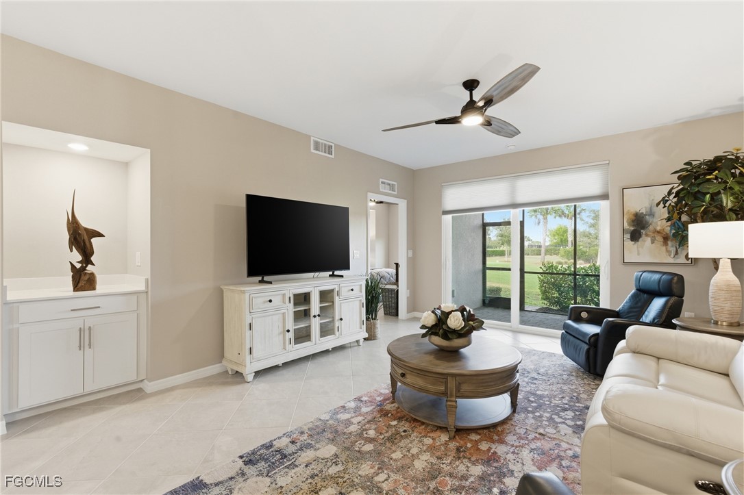 44000 Boardwalk Loop, Unit 1312 Punta Gorda, FL 33982 - Photo 5 of 48 a living room with furniture and a flat screen tv