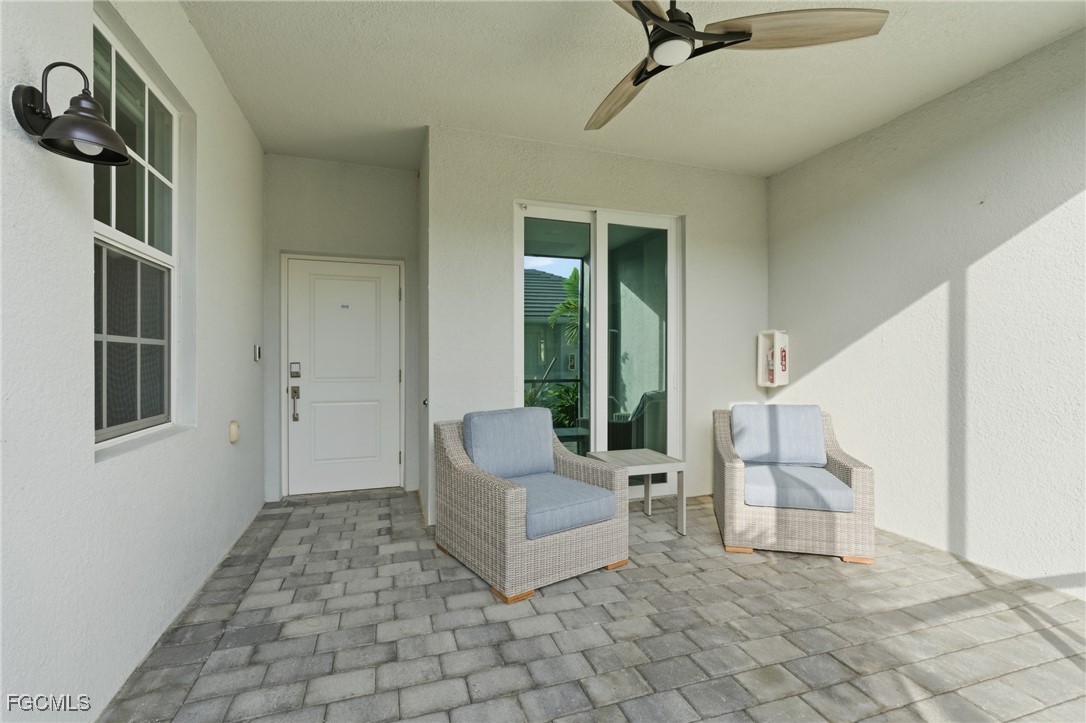 44000 Boardwalk Loop, Unit 1312 Punta Gorda, FL 33982 - Photo 10 of 48 a living room with furniture and a floor to ceiling window