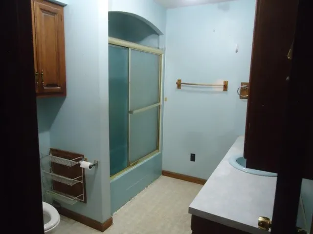 a kitchen with a sink a stove a dining table and chairs